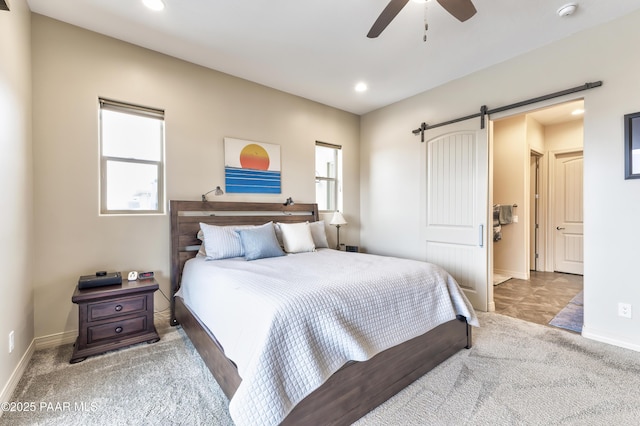 carpeted bedroom with baseboards, a barn door, ceiling fan, and recessed lighting