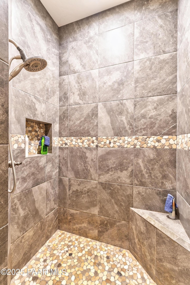 full bathroom featuring tiled shower