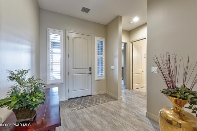 bathroom with double vanity, a sink, shower / bath combo with shower curtain, and visible vents