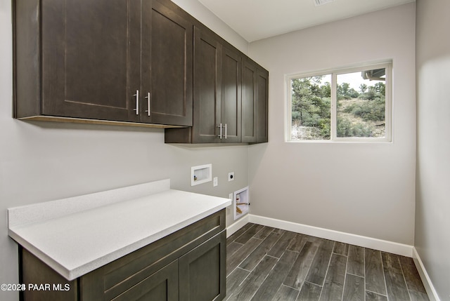 laundry room with cabinets, electric dryer hookup, dark hardwood / wood-style floors, and washer hookup