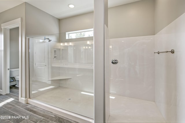 bathroom featuring toilet and walk in shower