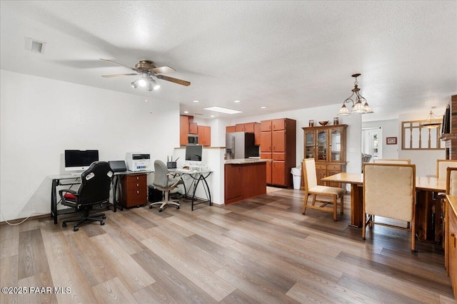 4860 N Treasure Cir, Prescott Valley, AZ 86314 - office space with light wood-type flooring, a ceiling fan, a textured ceiling, and a chandelier