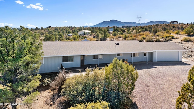 single story home featuring a garage and a mountain view