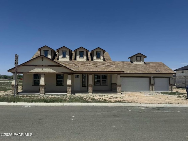 2545 Connor Ave, Chino Valley, AZ 86323 - view of front of home with covered porch, an attached garage, and brick siding