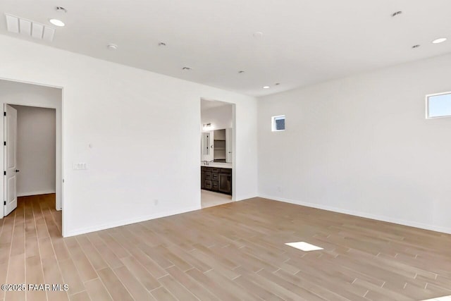 empty room with light hardwood / wood-style flooring