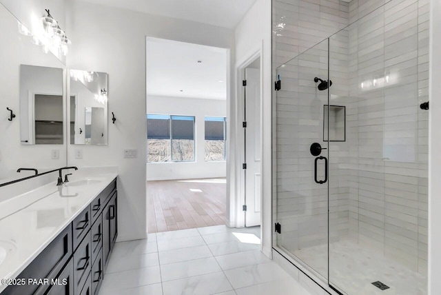 bathroom with an enclosed shower, vanity, and tile patterned floors