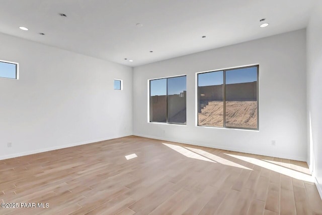 spare room with light hardwood / wood-style flooring