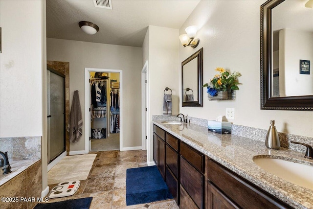 2360 W Bridle Path Rd, Prescott, AZ 86305 - full bath with double vanity, a shower stall, a walk in closet, a garden tub, and baseboards