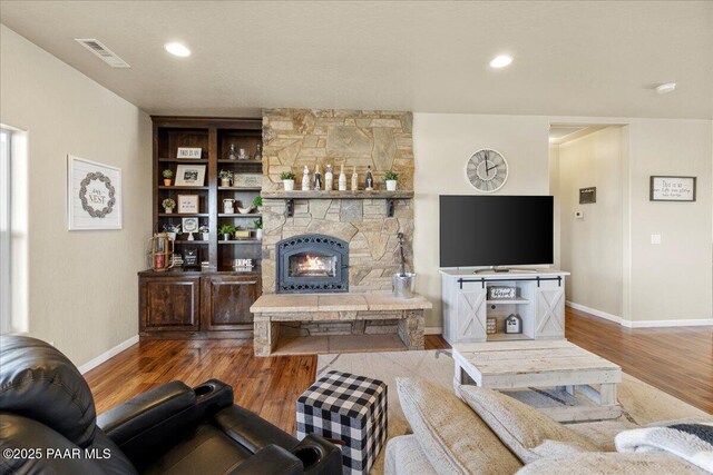 2360 W Bridle Path Rd, Prescott, AZ 86305 - living room with wood finished floors, baseboards, and a stone fireplace