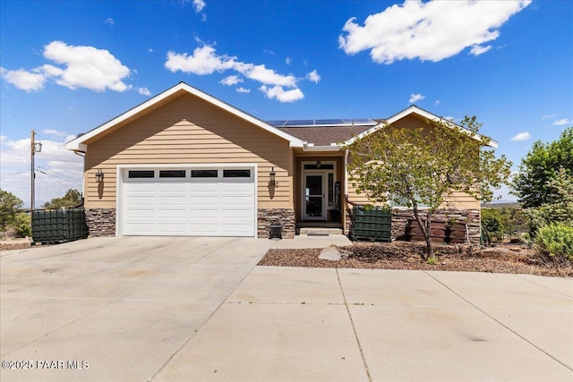 2360 W Bridle Path Rd, Prescott, AZ 86305 - ranch-style house featuring driveway, solar panels, stone siding, and a garage