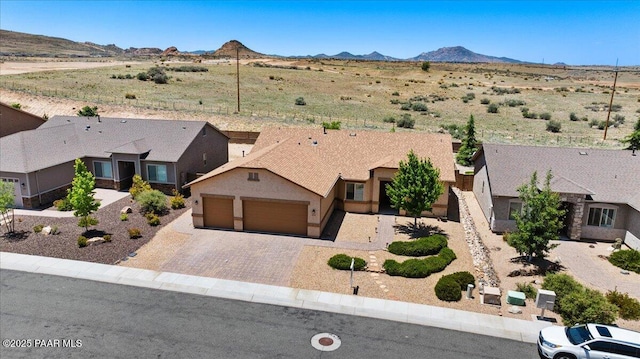 5510 N Foster Pl, Prescott Valley, AZ 86314 - view of front of house featuring an attached garage, a mountain view, decorative driveway, and stucco siding