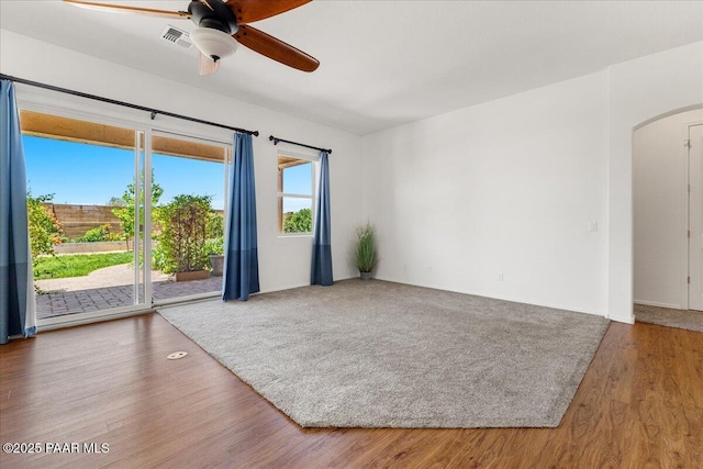 5510 N Foster Pl, Prescott Valley, AZ 86314 - spare room featuring arched walkways, a ceiling fan, and wood finished floors
