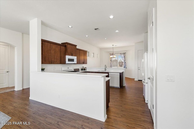 5510 N Foster Pl, Prescott Valley, AZ 86314 - kitchen with white appliances, a peninsula, light countertops, dark wood-style floors, and recessed lighting