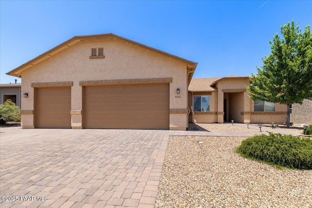5510 N Foster Pl, Prescott Valley, AZ 86314 - view of front of home featuring stucco siding, an attached garage, and decorative driveway
