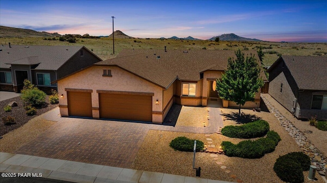 5510 N Foster Pl, Prescott Valley, AZ 86314 - view of front of property featuring a garage, stucco siding, decorative driveway, and a mountain view