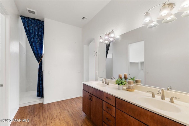 5510 N Foster Pl, Prescott Valley, AZ 86314 - bathroom featuring double vanity, wood finished floors, and a chandelier