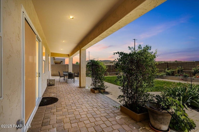 5510 N Foster Pl, Prescott Valley, AZ 86314 - patio terrace at dusk featuring a patio area, outdoor dining space, and a fenced backyard