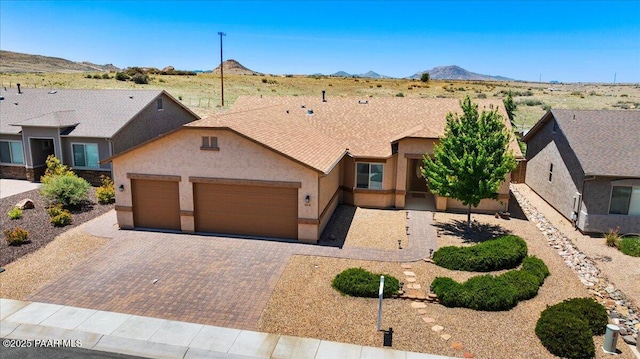 5510 N Foster Pl, Prescott Valley, AZ 86314 - single story home with stucco siding, a garage, decorative driveway, and a mountain view