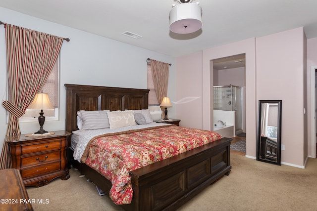 carpeted bedroom with ensuite bath