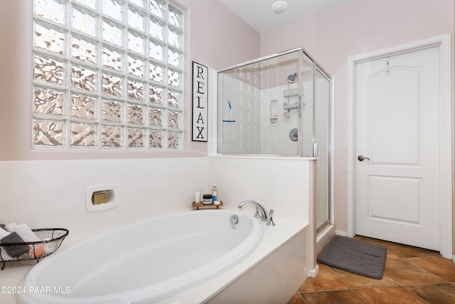 bathroom featuring separate shower and tub