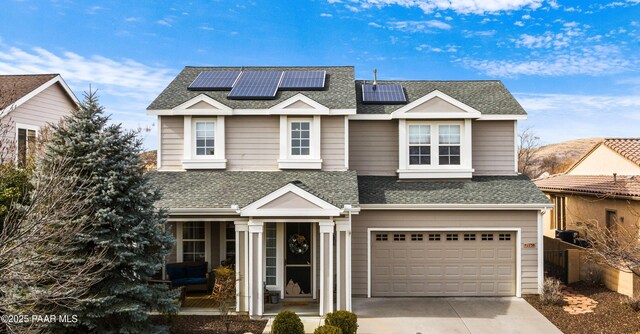 view of front property with solar panels and a garage