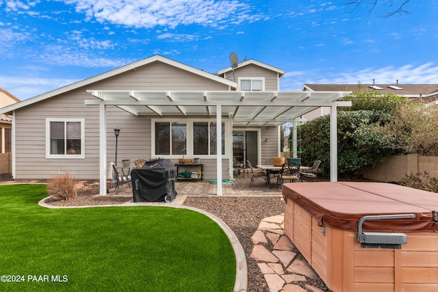 back of property with a lawn, a pergola, a patio, and a hot tub