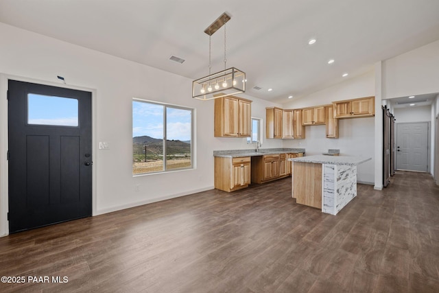 13555 E Soleil Down Rd, Mayer, AZ 86333 - kitchen with a center island, dark wood-type flooring, vaulted ceiling, pendant lighting, and light brown cabinets