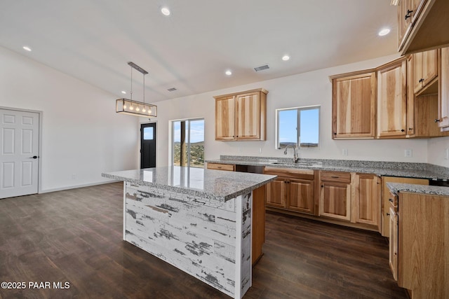 13555 E Soleil Down Rd, Mayer, AZ 86333 - kitchen with light stone counters, dark wood-style flooring, recessed lighting, and a kitchen island