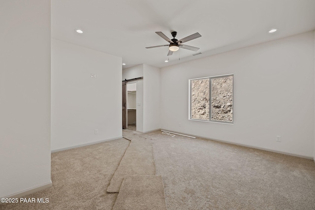 13555 E Soleil Down Rd, Mayer, AZ 86333 - carpeted spare room featuring ceiling fan, a barn door, and recessed lighting