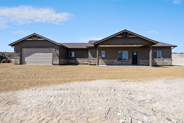 13555 E Soleil Down Rd, Mayer, AZ 86333 - ranch-style house with stone siding, stucco siding, a garage, and dirt driveway