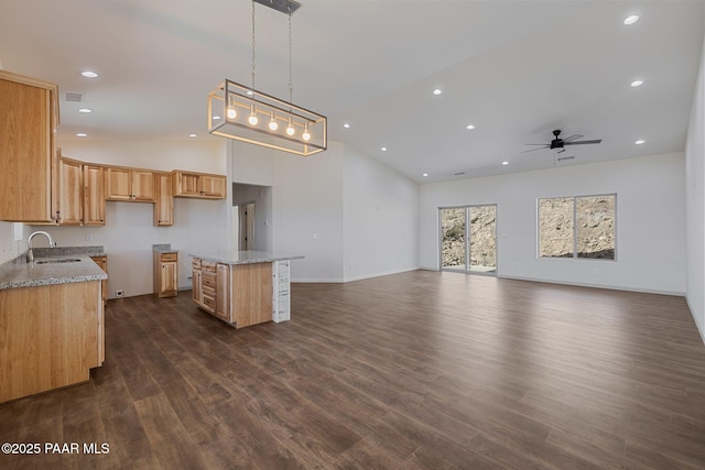 13555 E Soleil Down Rd, Mayer, AZ 86333 - kitchen featuring dark wood-type flooring, a ceiling fan, a center island, high vaulted ceiling, and light stone counters