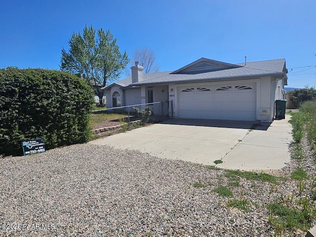 ranch-style house with fence, driveway, stucco siding, and a garage