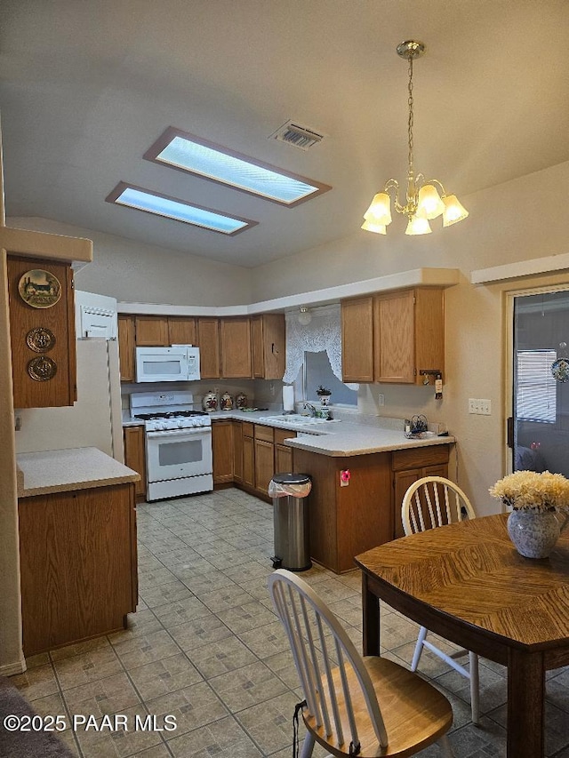 4825 E Sauter Dr, Prescott Valley, AZ 86314 - kitchen with light countertops, lofted ceiling with skylight, visible vents, and white appliances