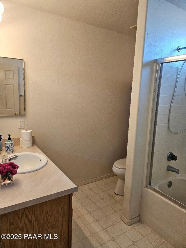 4825 E Sauter Dr, Prescott Valley, AZ 86314 - bathroom featuring tile patterned floors, toilet, shower / bathtub combination, a textured wall, and vanity
