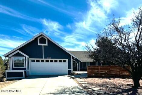 view of front of property featuring a garage and driveway