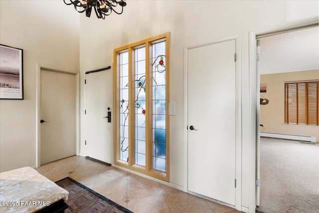 10875 E Manzanita Trl, Dewey-Humboldt, AZ 86327 - entryway with baseboard heating, a chandelier, tile patterned flooring, and a high ceiling