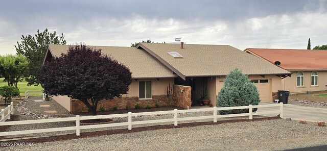 10875 E Manzanita Trl, Dewey-Humboldt, AZ 86327 - view of front of property featuring an attached garage, a fenced front yard, and stone siding