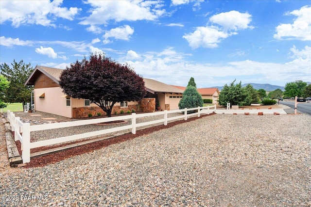10875 E Manzanita Trl, Dewey-Humboldt, AZ 86327 - view of property hidden behind natural elements with a garage, driveway, and stone siding