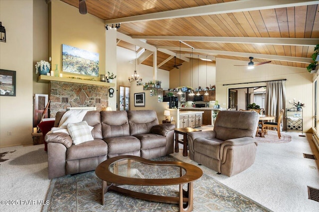 10875 E Manzanita Trl, Dewey-Humboldt, AZ 86327 - living room featuring carpet, a ceiling fan, wood ceiling, a stone fireplace, and a chandelier