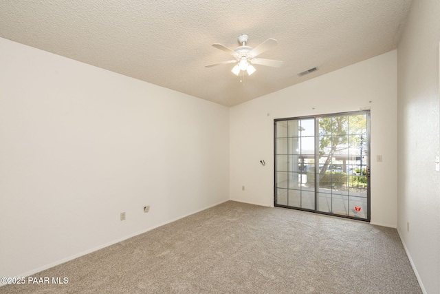 spare room featuring a textured ceiling, visible vents, vaulted ceiling, light carpet, and a ceiling fan