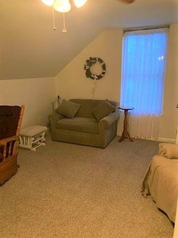 carpeted living room featuring lofted ceiling and ceiling fan