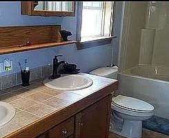 full bathroom featuring  shower combination, toilet, and vanity