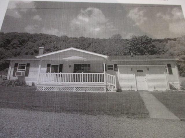 single story home featuring covered porch