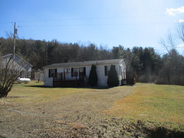 view of front of property with a front yard and a deck