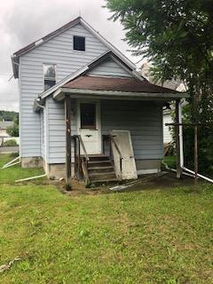 rear view of property featuring a yard