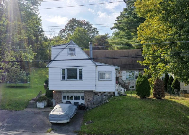 exterior space featuring a lawn and a garage