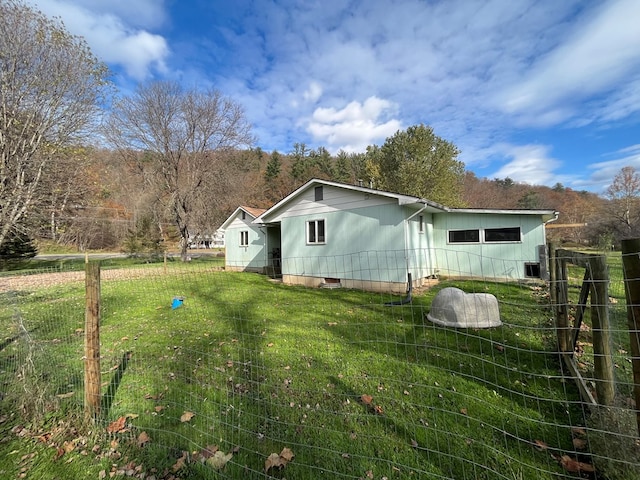 view of side of home featuring a yard