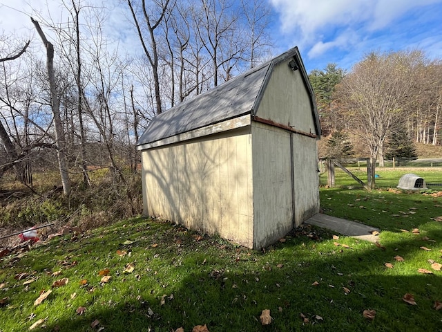 view of outbuilding featuring a lawn