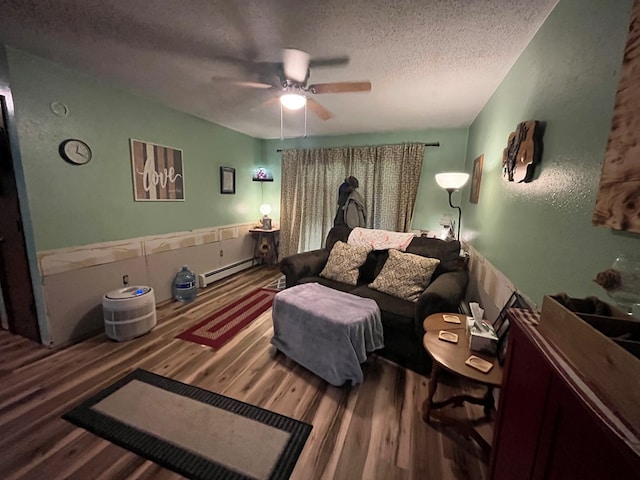 living room featuring hardwood / wood-style floors, a textured ceiling, a baseboard radiator, and ceiling fan