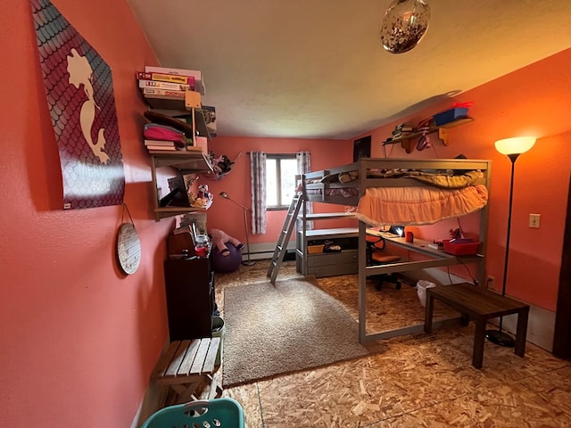 bedroom with a baseboard heating unit and lofted ceiling